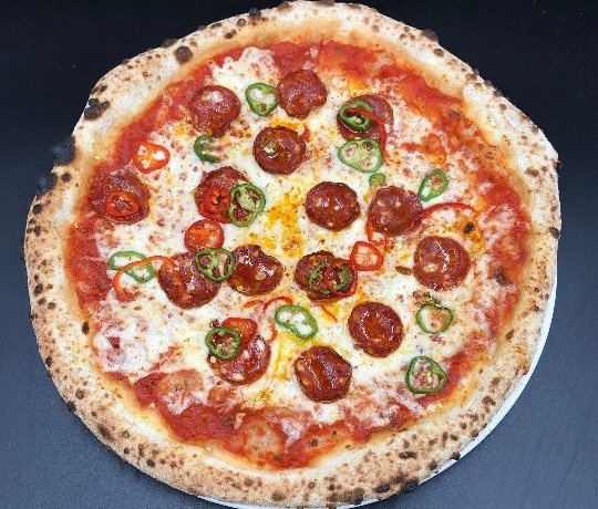Delicious Pepperoni Pizzas with local ingredients Delicious Pepperoni Pizzas with local ingredients